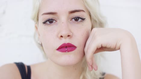 serious young blond woman staring at the camera