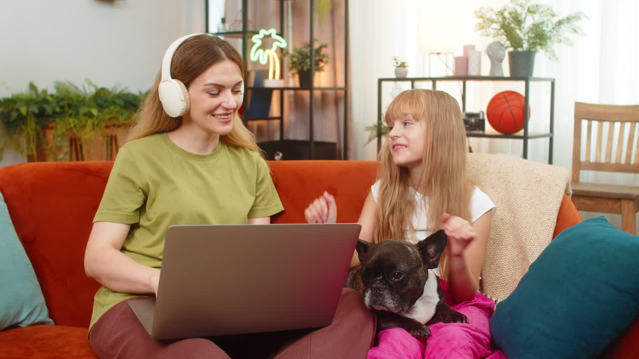 Mother daughter dog wireless headphones music work on laptop sing along together focus create flow