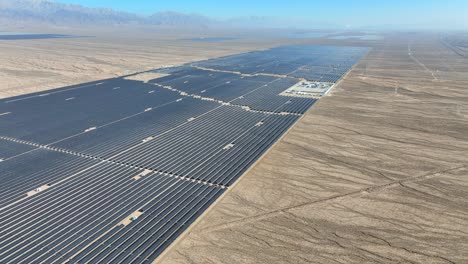 expansive solar panels sprawling across desert, sunny day, aerial view