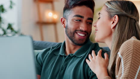 happy couple with laptop on sofa for real estate