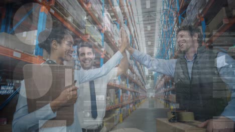 Animation-of-financial-graphs-over-happy-diverse-female-and-male-warehouse-workers-clapping-hands