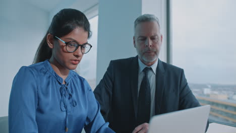 business colleagues working on laptop in office