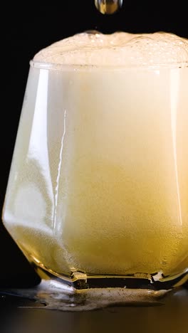 pouring a beer with frothy foam