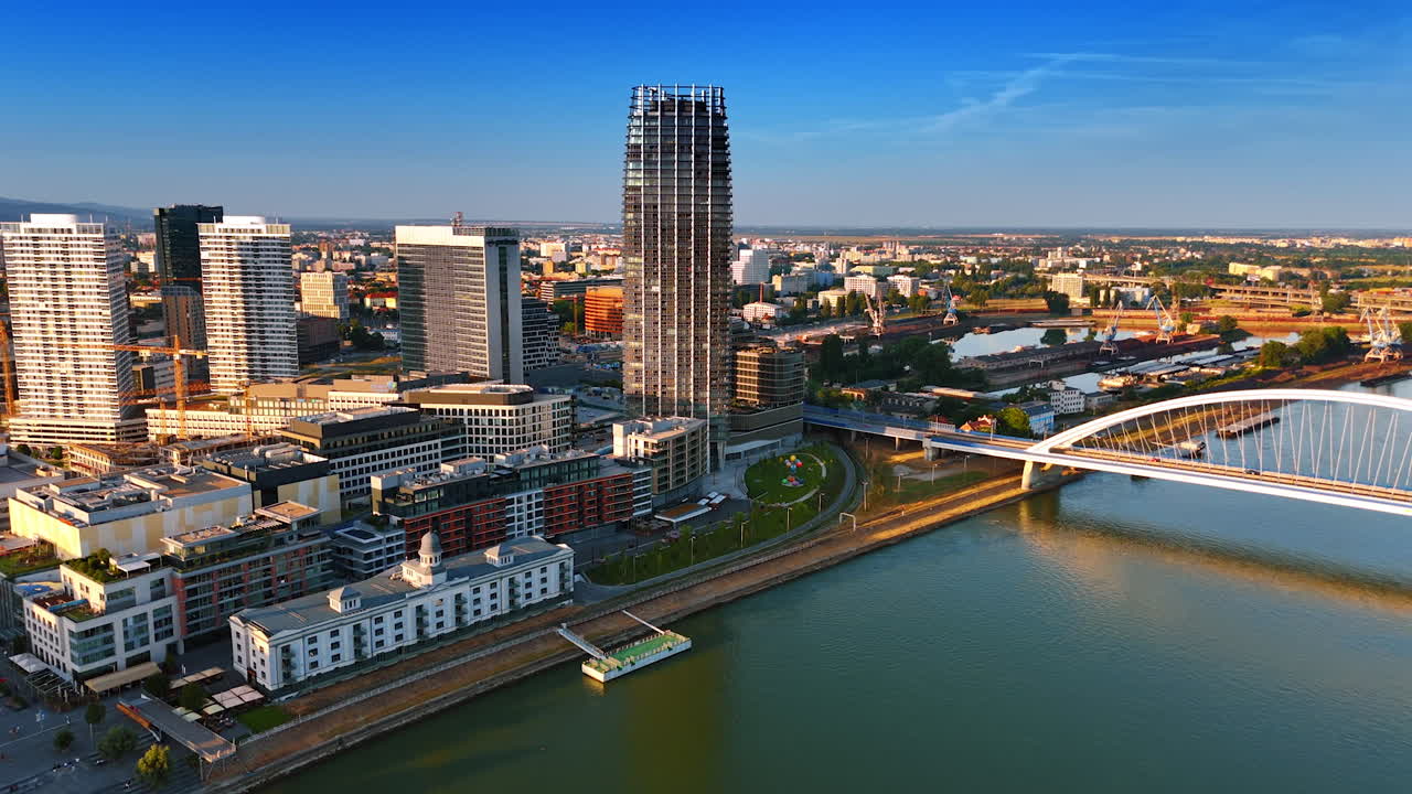 Footage above the Danube River close to the Appolo Bridge from drone. View on the modern urban landscape of Bratislava, Slovakia