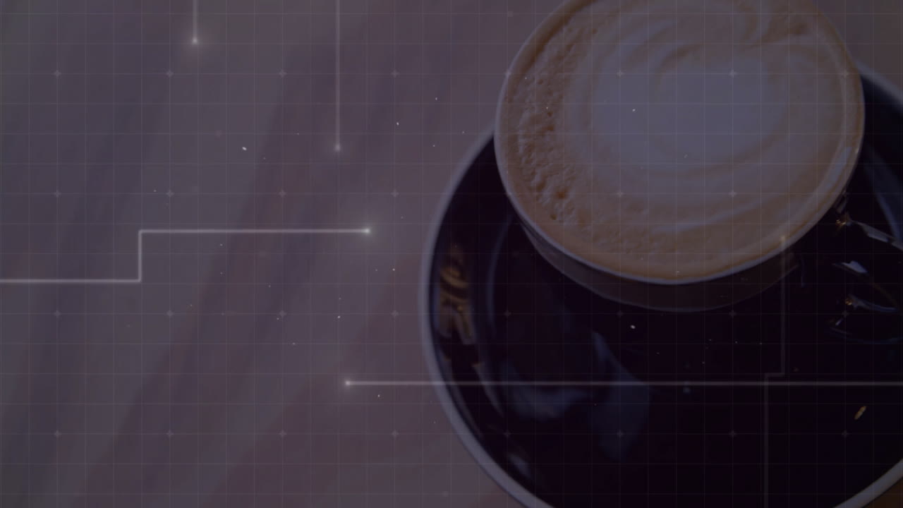 Black coffee cup being displayed on wooden table, featuring latte art and digital grid overlay