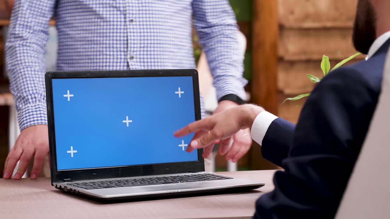 Laptop with chroma key in office