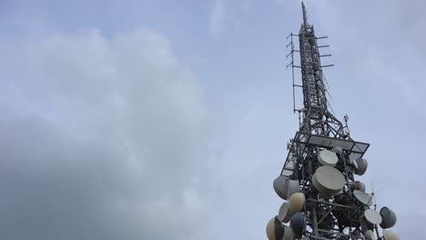 big telecommunication antenna tower with repeater on a cloudy day, 4k timelapse