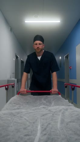 doctor pushing a stretcher in a hospital hallway