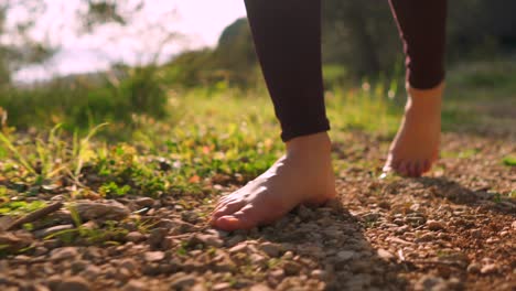 free young woman walking barefoot through forest, sunrise peaceful nature walk