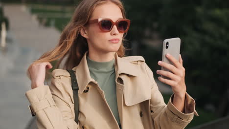 caucasian female student video calling outdoors.