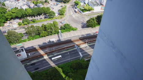 facing downwards static shot of a busy road in hong kong as seen from the top of a skyscraper