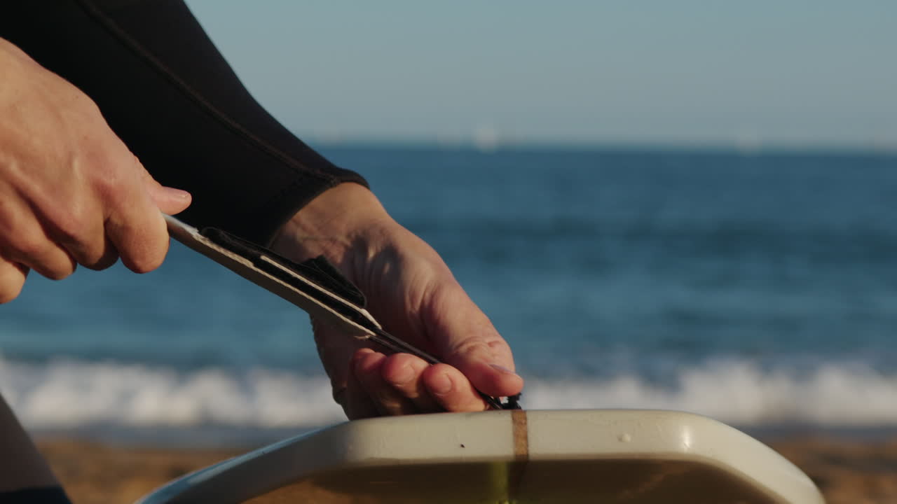 Surfer man walking to the beach at sunset preparing for surfing training and search for waves in Barcelona, spain, water, ocean exercise in sea with board, athletic male holiday or travel in vacation