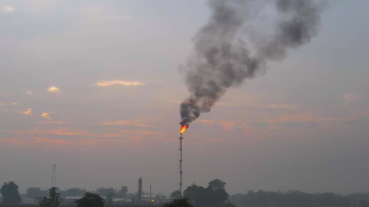 Flames from the chimney of the gas refinery burn waste product hydrocarbons