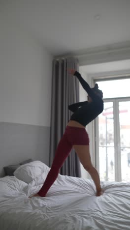 Woman dancing on a bed