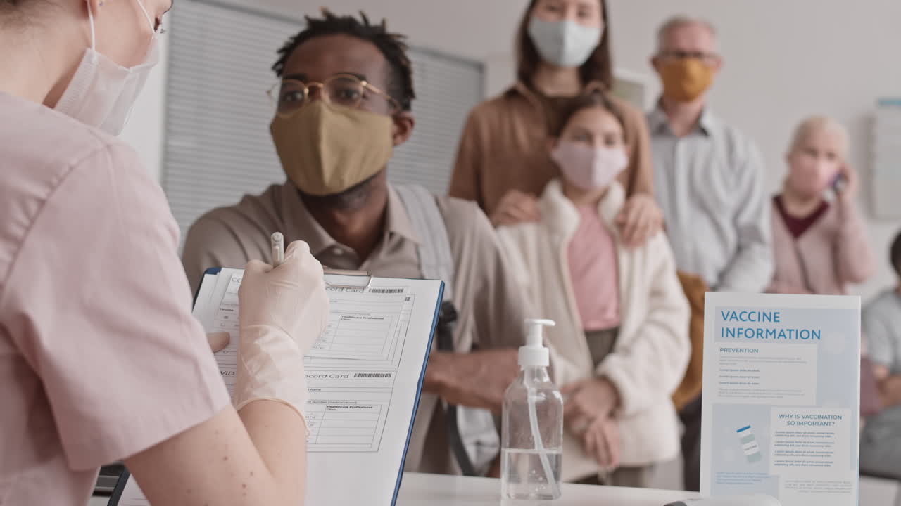 Nurse Registering Patients for Vaccination