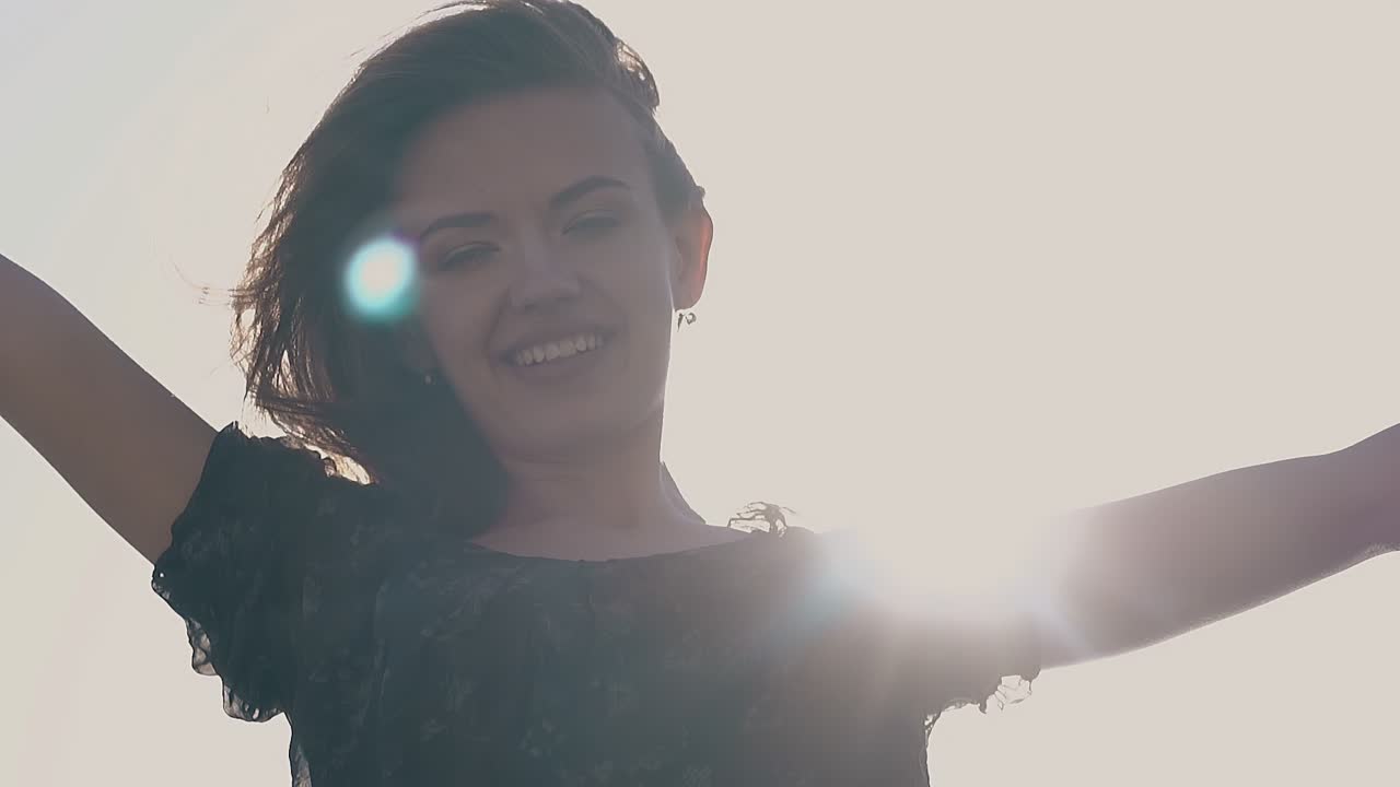 드레스를 입은 여자가 손을 들고 서서히 움직입니다.