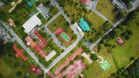 Cinematic-Drone-Footage-of-Palm-Oil-Mill-Effluent-residential-consists-of-buildings,-homes,-main-road-and-infrastructure-surrounded-by-palm-oil-trees-deforestation-located-in-Indonesia-in-full-HD