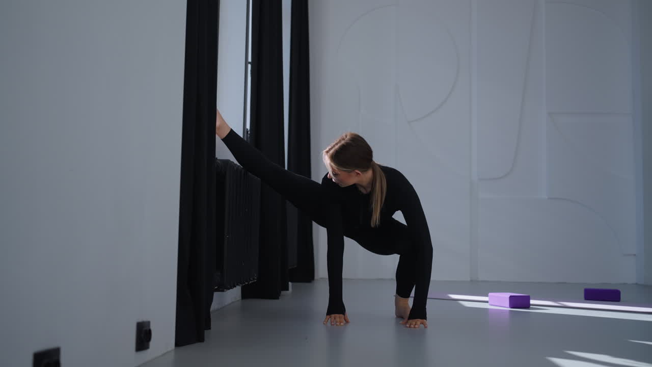 mujer estirándose en el estudio de yoga