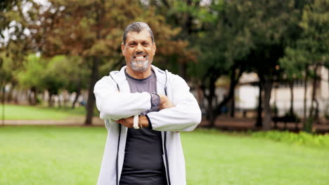 happy, fitness and arms crossed with man in park