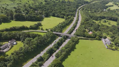 Aerial-orbital-view-of-the-A30-road-surrounded-by-Devon-countryside,-UK