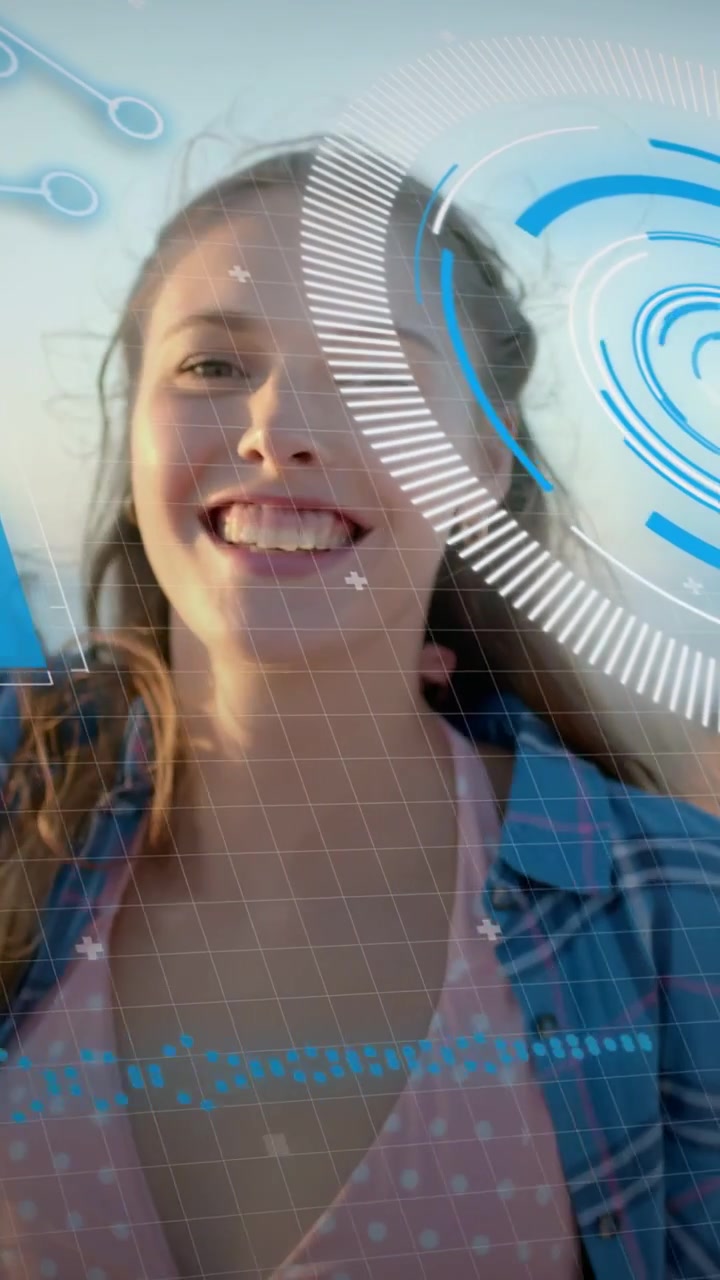 Vertical video: Woman raising arms at sea arm lift initiating AR overlay crossing torso celebrating