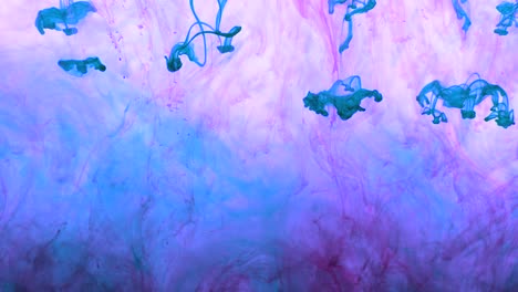 4k footage of colorful ink drops in water, isolated abstract background. pouring ink in water. underwater paint mix. slow psychedelic dye swirls, colored smoke explosion. splashing, floating liquid