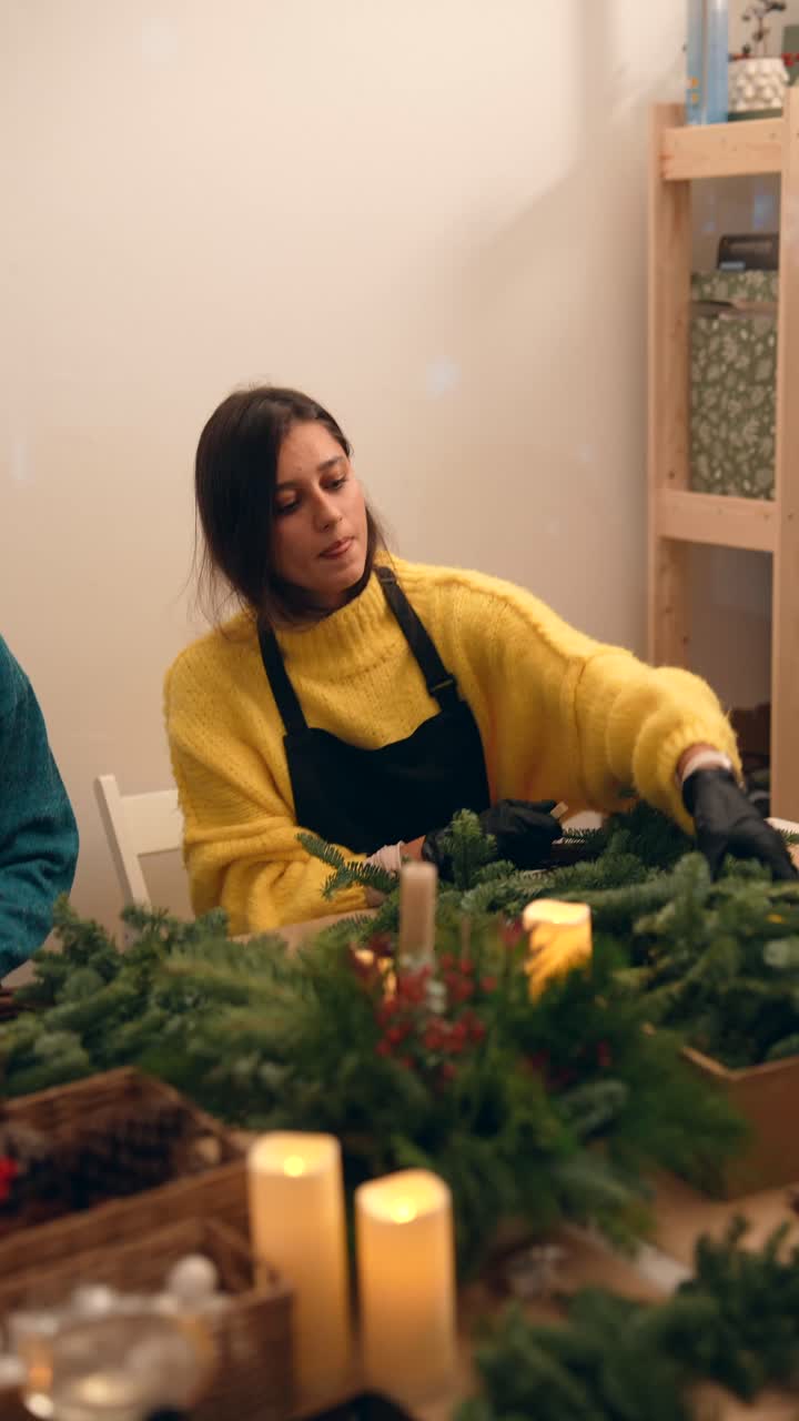 Woman Crafting Christmas Wreath with Candles