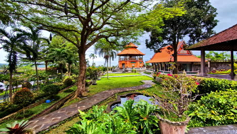 profile view of famous tirta gangga surrounded with greenery in bali, indonesia