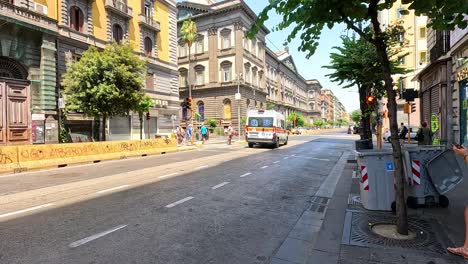 ambulance driving down a street in naples