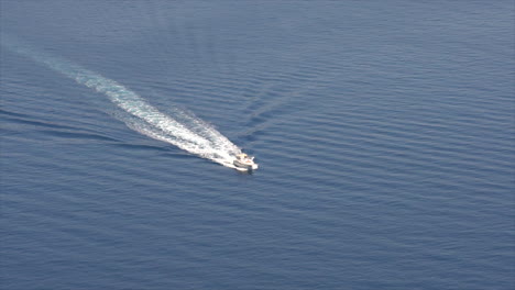 A-large-white-power-boat-sails-across-the-ocean