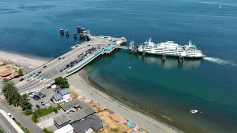 Orbiting-drone-shot-of-cars-exiting-the-Whidbey-Island-ferry-and-driving-onto-the-mainland