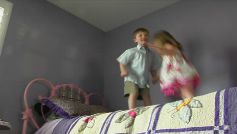 children jump on a bed