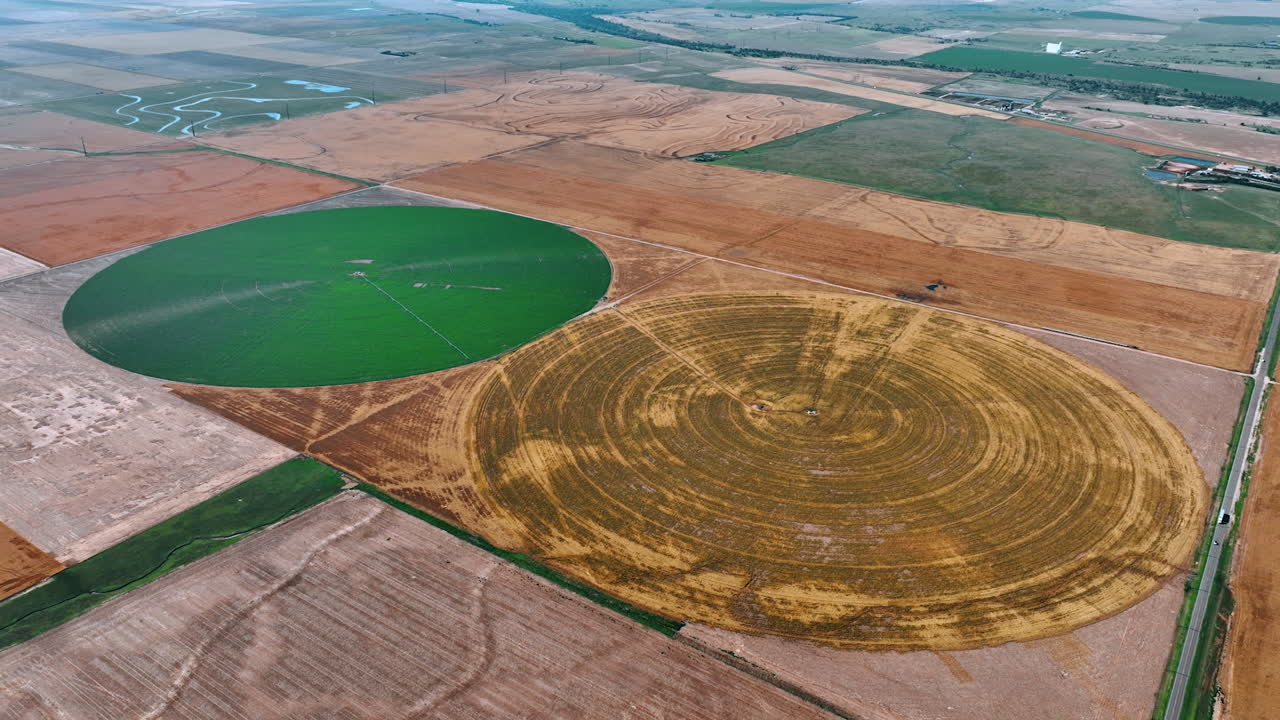 Two circle farms on the fields with center-pivot-irrigation systems. Agricultural plantations with and without vegetation. Top view.