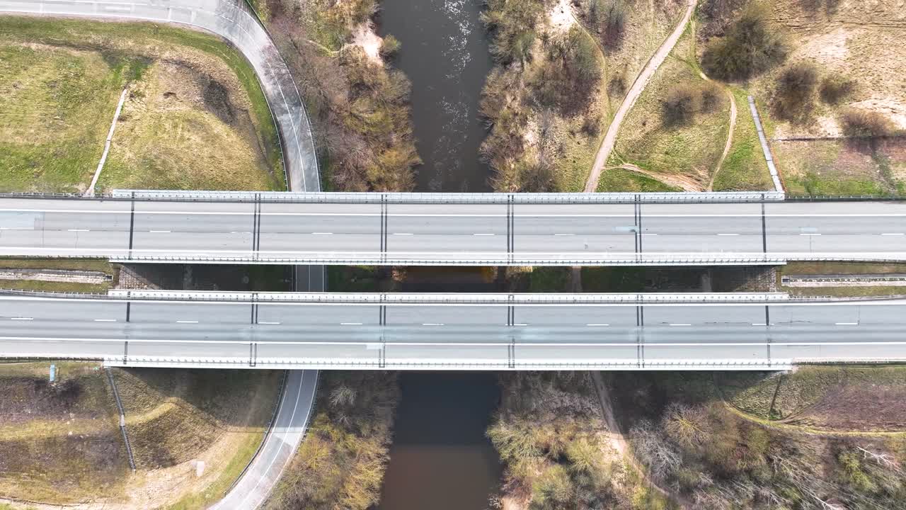 Aerila shot, the highway bridge crosses the river Minija, cars run on the highway.