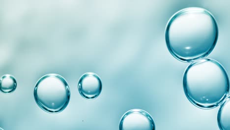 sidewards drifting transparent bubbles in low angle on blue background