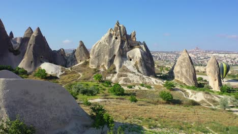 Rock-cut-caves-in-Cappadocia-landscape,-forward-aerial