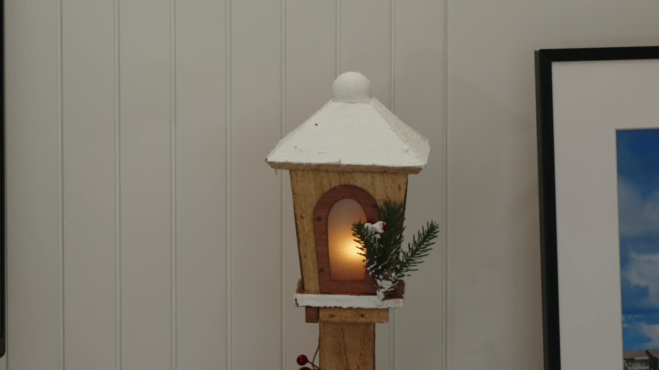 rustic holiday lantern glowing with soft light and festive greenery