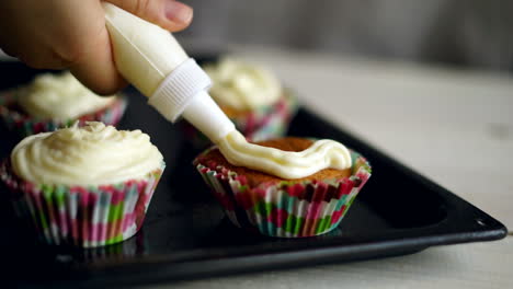 chef making muffins. muffins decoration. cupcakes decorating with whipped cream