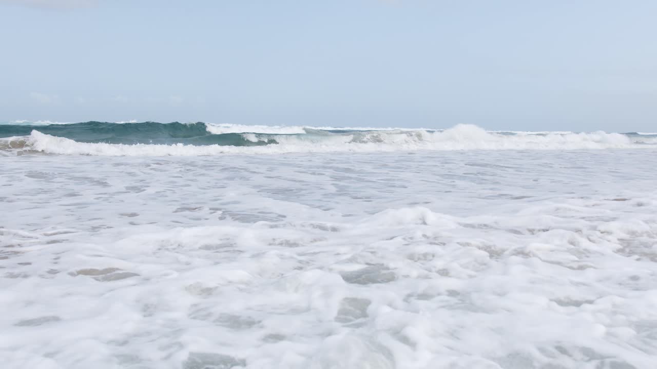 바다 거품을 만드는 해변에 오는 파도