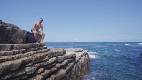 young man sitting on the seashore.