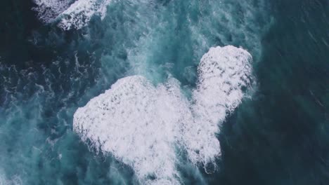 Stunning-aerial-footage-of-waves-crashing-and-creating-a-unique-pattern-on-the-North-Shore-of-Oahu,-Hawaii