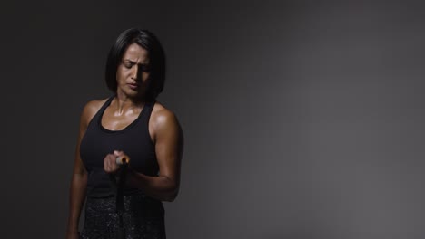 Studio-Shot-Of-Mature-Woman-Wearing-Gym-Fitness-Clothing-Exercising-With-Resistance-Band-2