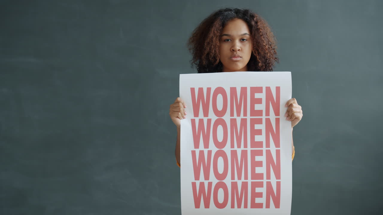 Woman Holding a Protest Sign for Women's Rights