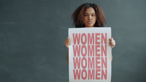 Woman Holding a Protest Sign for Women's Rights