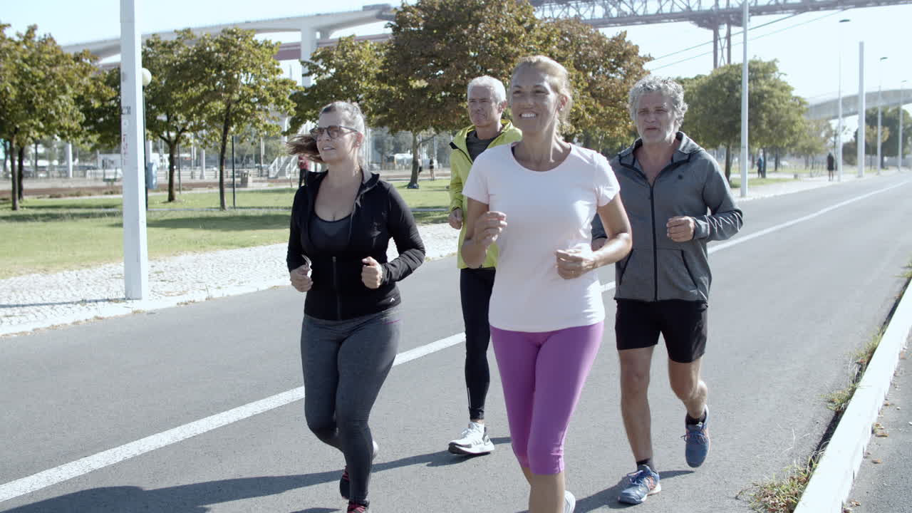 Active elder joggers running down street
