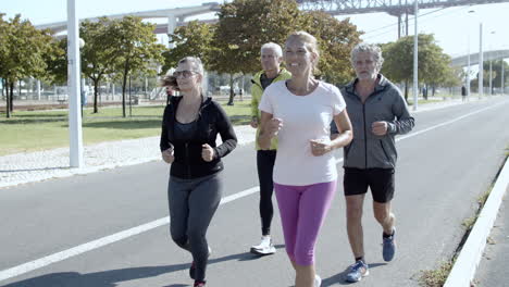 active elder joggers running down street