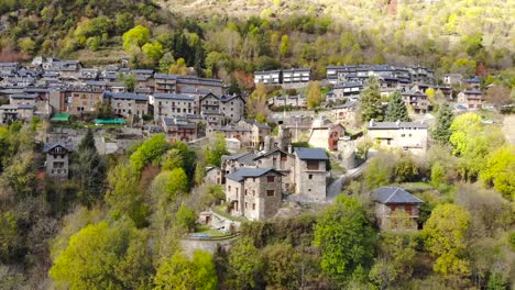 aerial: small town in mountainous terrain in the catalan countryside