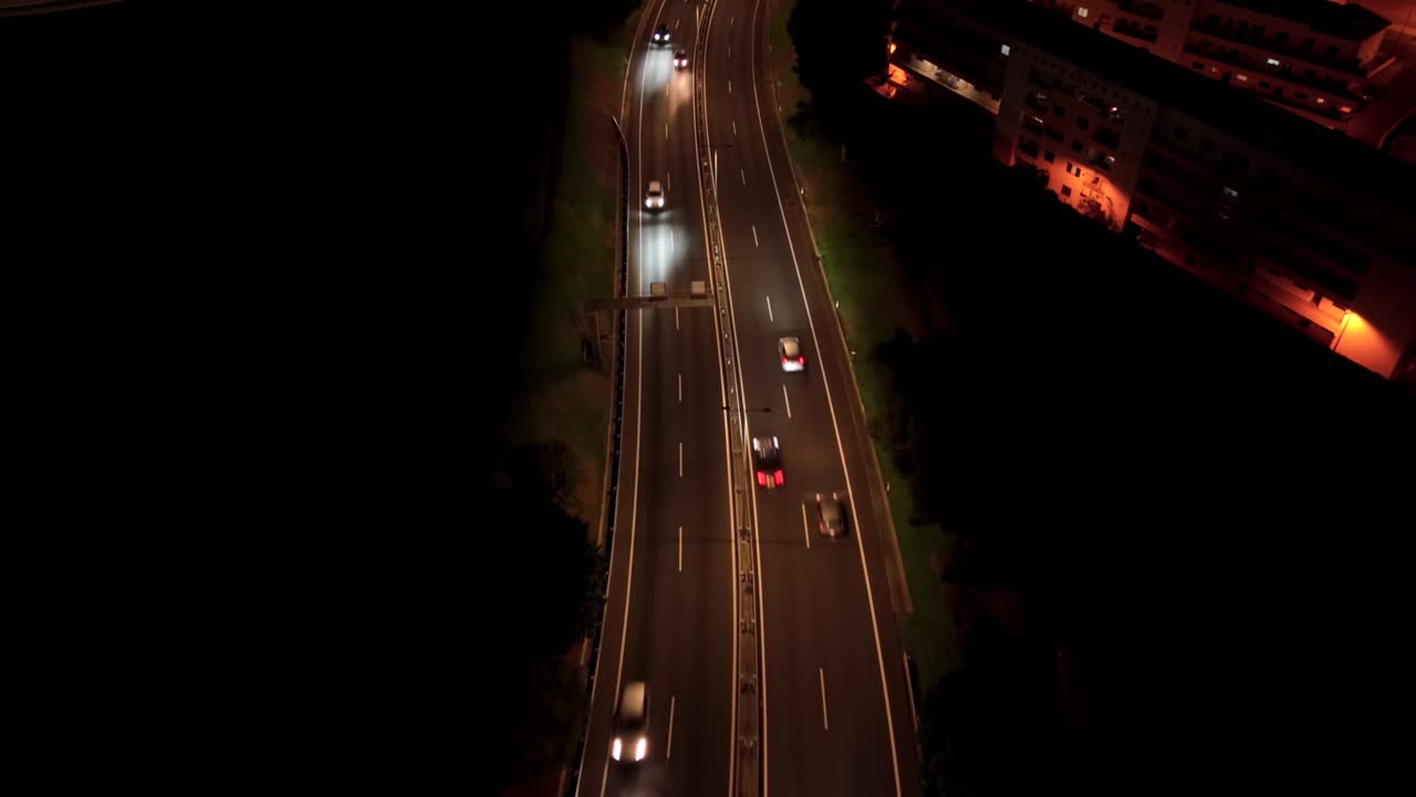Birds eye view drone shot traffic hyperlapse in urban city at night