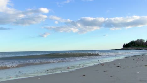 waves crashing on local beach on cape cod during sunset