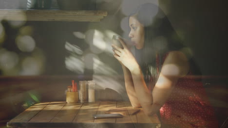 glowing spots of light against woman drinking coffee